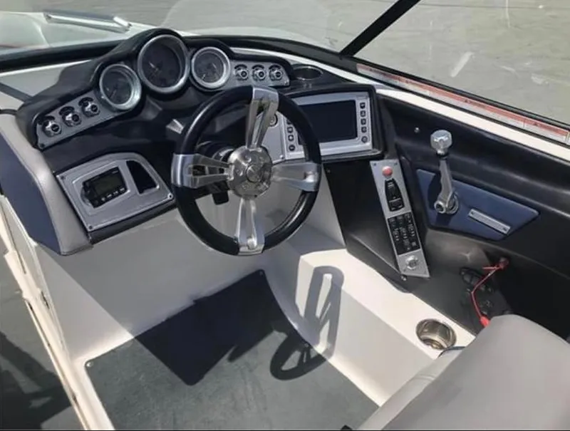 Slide: The Image of 2014 MasterCraft X-55 boat dashboard with steering wheel and control panel. - 29
