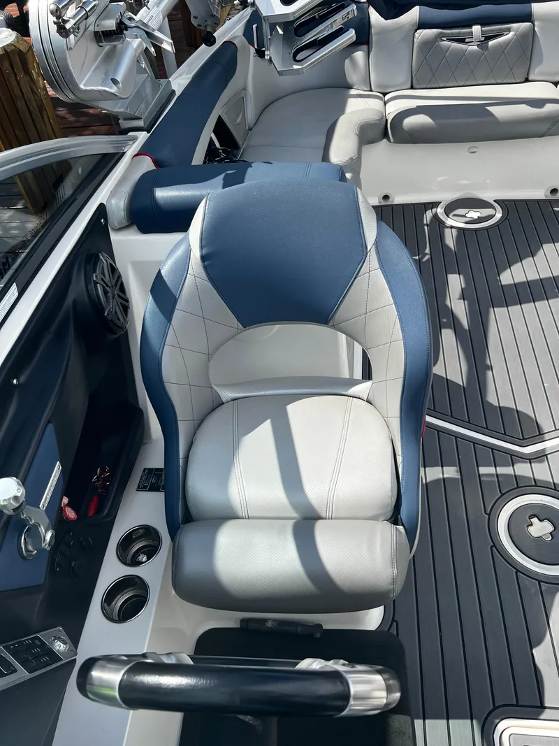 Slide: The Image of 2014 MasterCraft X-55 boat interior with blue and white seating. - 30