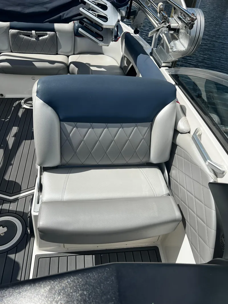 Slide: The Image of 2014 MasterCraft X-55 boat interior with gray and blue diamond-stitched seating. - 31