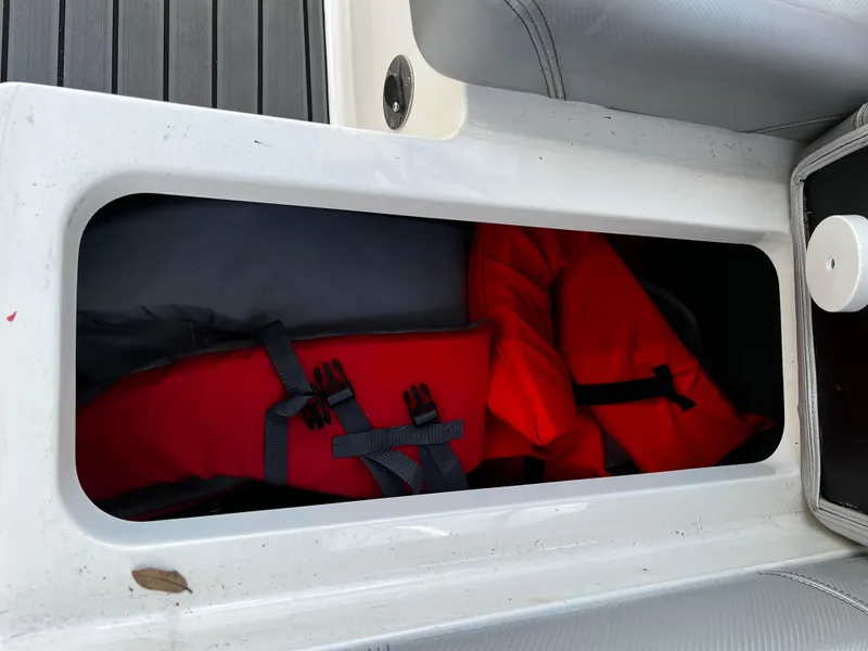 Slide: The Image of Storage compartment with life jackets in a 2014 MasterCraft X-55 boat. - 40