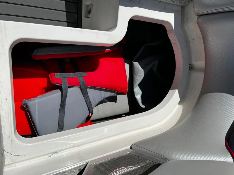 Slide: The Image of Storage compartment of a 2014 MasterCraft X-55 boat with red and gray life jackets. - 43