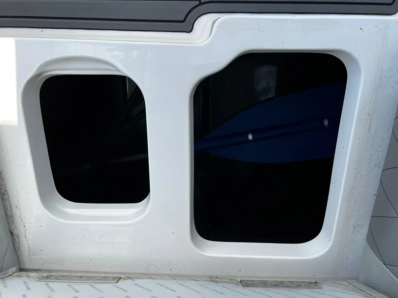 Slide: The Image of Storage compartment of a 2014 MasterCraft X-55 boat with paddle inside. - 46