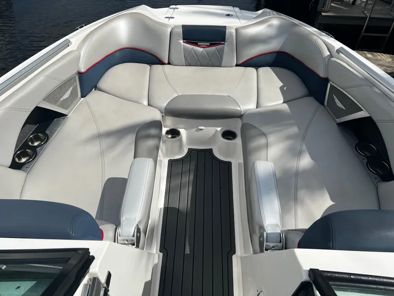 Slide: The Image of 2014 MasterCraft X-55 boat interior with spacious seating and cup holders. - 6