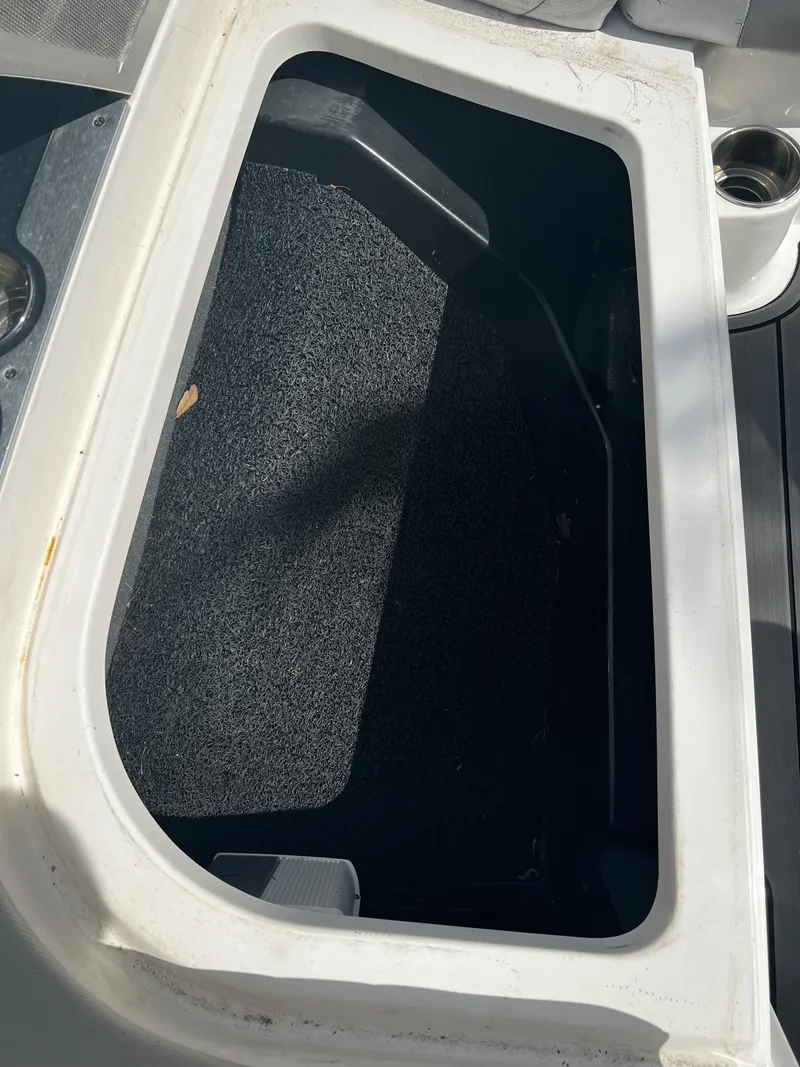 Slide: The Image of Storage compartment of a 2014 MasterCraft X-55 boat with carpeted interior. - 9