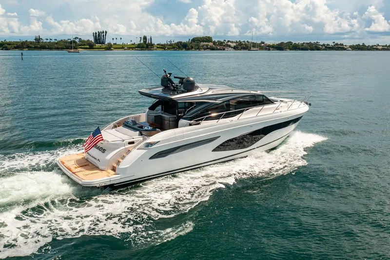 Slide: The Image of The 2020 Princess V60 cruising on calm waters with an American flag at the stern. - 3