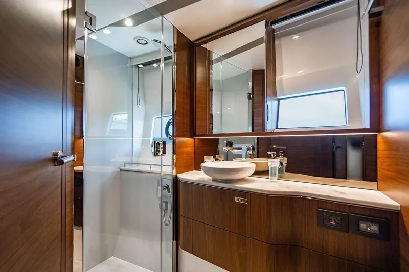 Slide: The Image of Luxurious bathroom with wood paneling, glass shower, and modern sink on a yacht. - 25