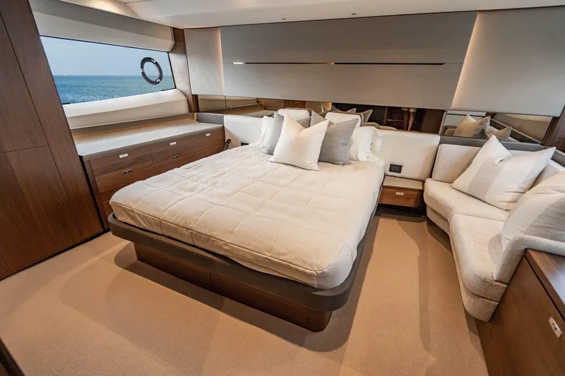 Slide: The Image of Luxurious cabin with a large bed, elegant wood furnishings, and a sea view. - 28