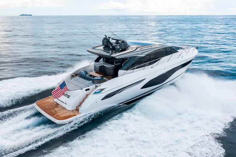 Slide: The Image of 2020 Princess V60 yacht cruising on the sea, featuring sleek design and an American flag. - 6
