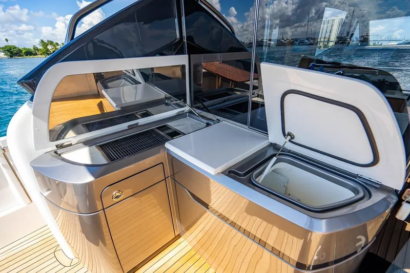 Slide: The Image of The 2020 Princess V60 features a modern outdoor kitchen with a grill and refrigerator. - 17