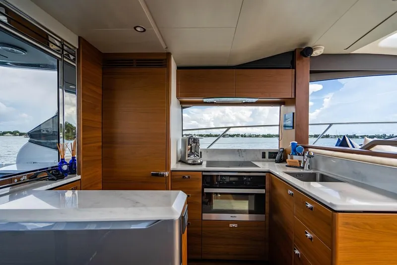 Slide: The Image of The 2020 Princess V60 kitchen with wooden cabinets and modern appliances. - 23
