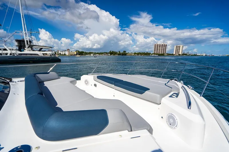 Slide: The Image of The image shows the foredeck of a luxury yacht with comfortable cushions and a view of the coastline. - 14