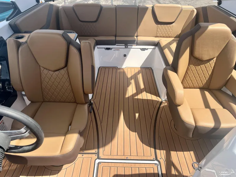 Slide: The Image of 2025 Yamaha Boats 252SE interior with tan leather seating and wood-style flooring. - 10