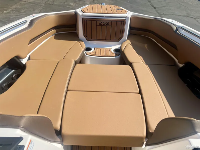 Slide: The Image of 2025 Yamaha Boats 252SE interior with tan seating and wood accents. - 2