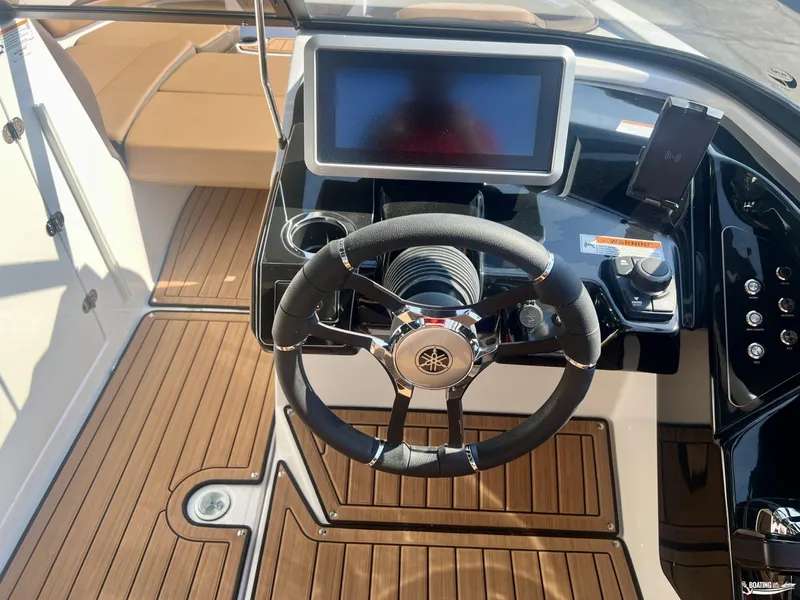 Slide: The Image of 2025 Yamaha Boats 252SE steering console with modern controls and wood finish. - 3