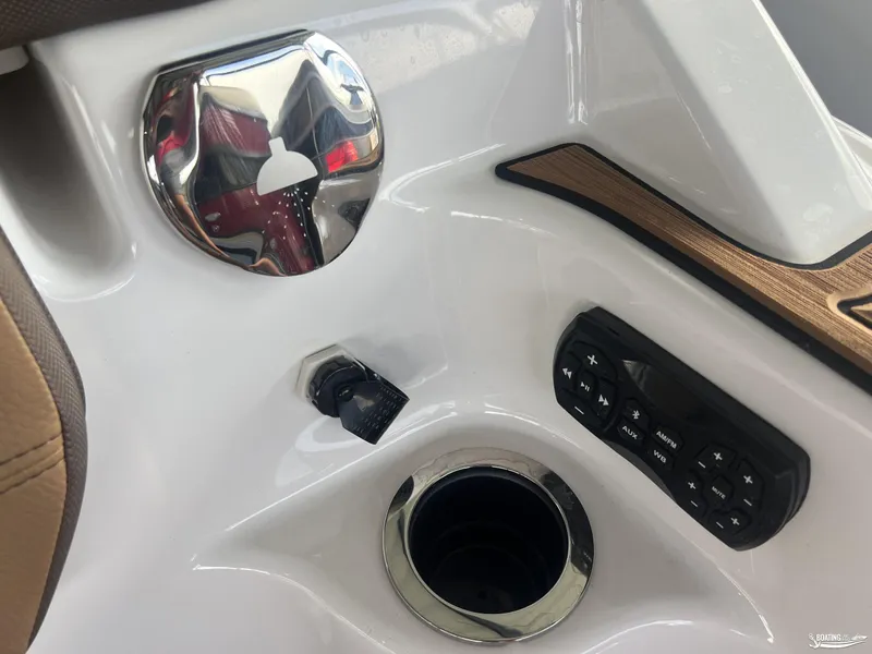 Slide: The Image of 2025 Yamaha Boats 252SE dashboard with control panel and cup holder. - 7