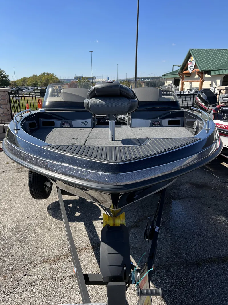 Slide: The Image of 2023 Ranger 620FS Pro fishing boat on a trailer in a parking lot. - 2