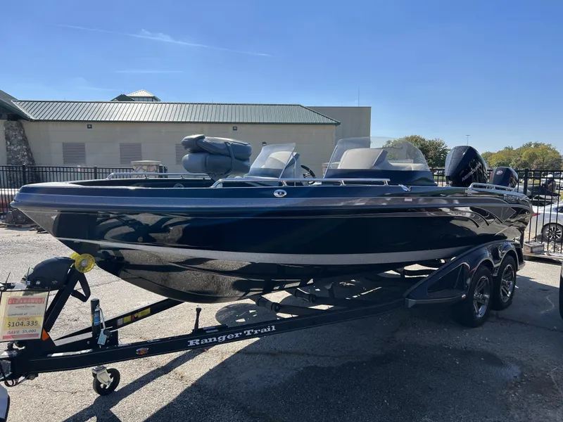 Slide: The Image of 2023 Ranger 620FS Pro fishing boat on a trailer in a parking lot. - 3