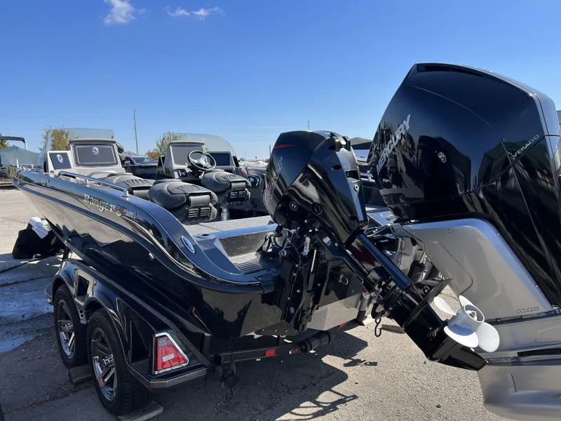 Slide: The Image of 2023 Ranger 620FS Pro boat with powerful outboard motor in a parking lot. - 4