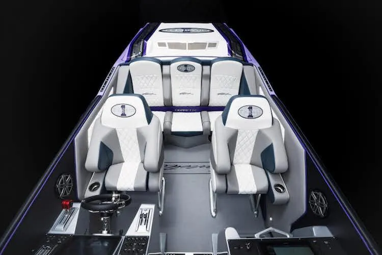 Slide: The Image of 2025 Cigarette 42' X boat interior with luxurious white and blue seating. - 10
