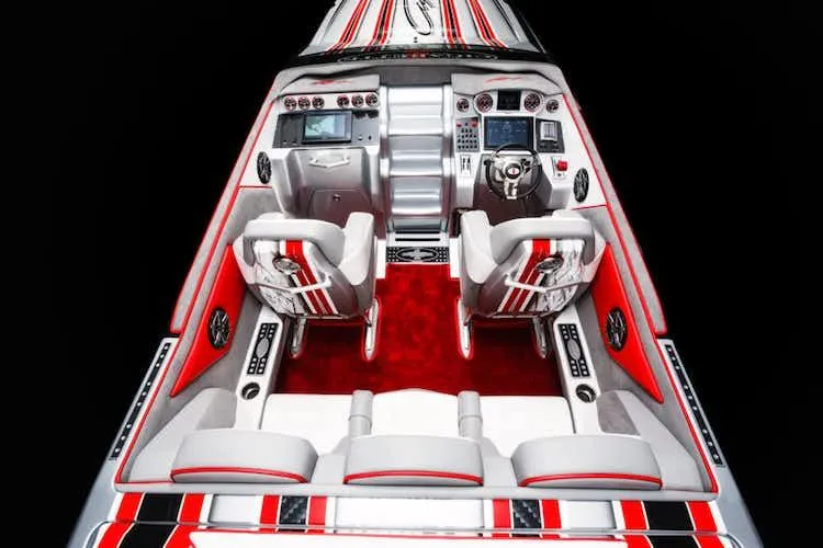 Slide: The Image of 2025 Cigarette 42' X boat interior with red and white seating and advanced dashboard. - 7