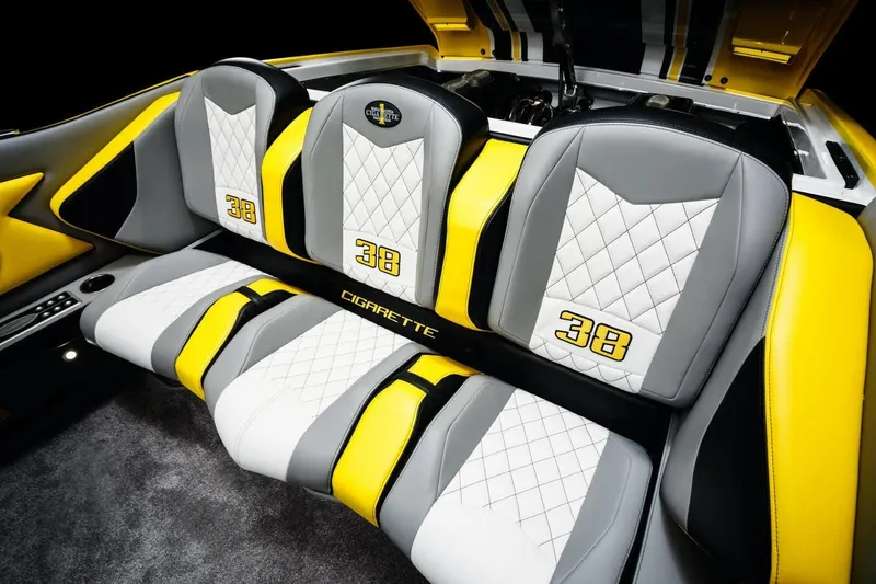 Slide: The Image of Interior of 2025 Cigarette 38 Top Gun boat with yellow, white, and gray seats. - 9