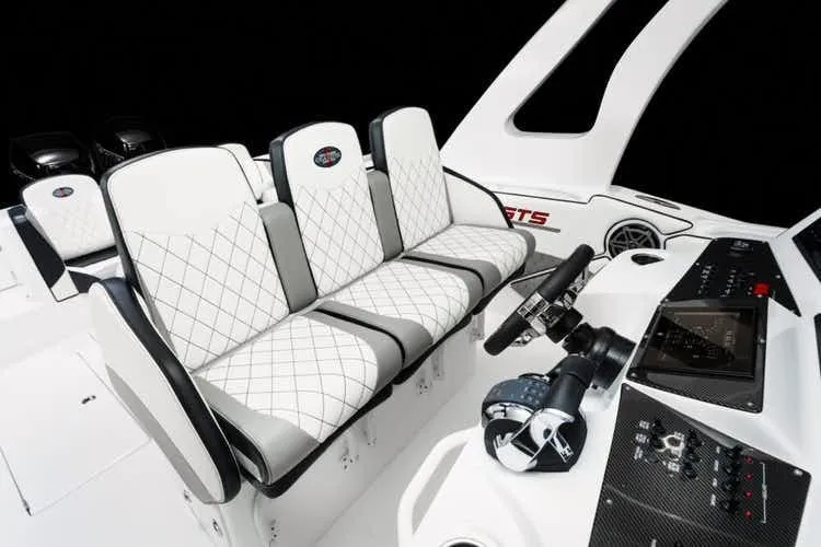 Slide: The Image of 2025 Cigarette 39 GTS boat interior with white diamond-stitched seats and modern control panel. - 10