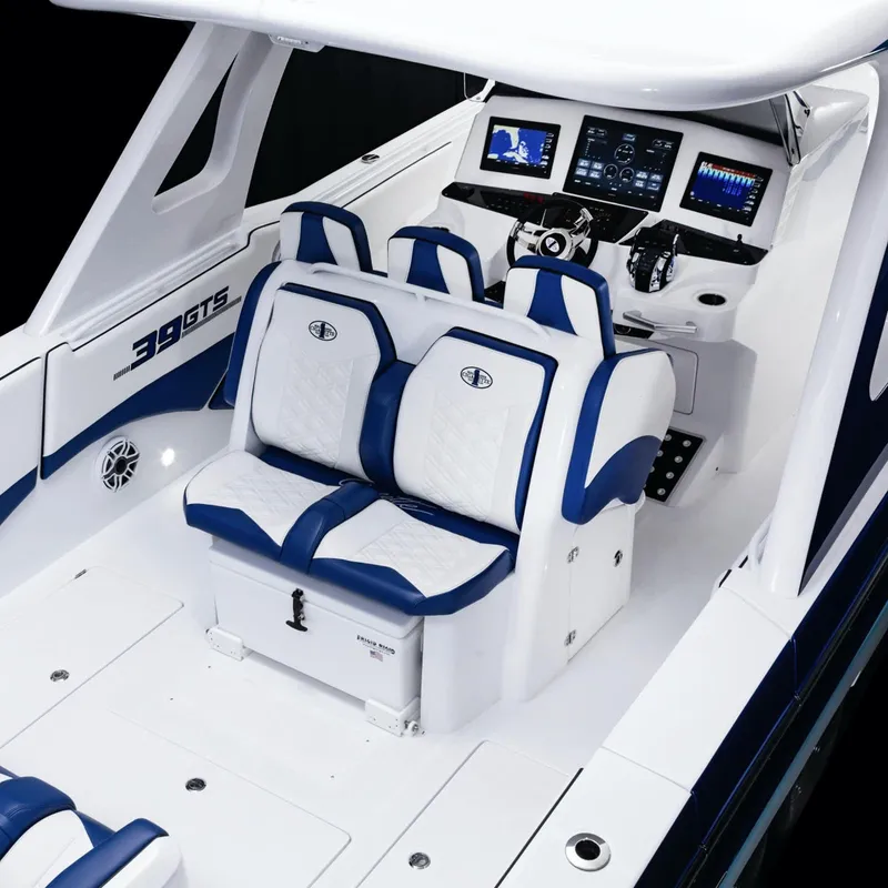 Slide: The Image of 2025 Cigarette 39 GTS boat interior with white and blue seating and advanced dashboard. - 11