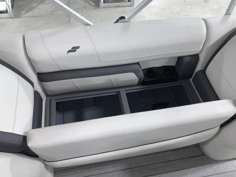 Slide: The Image of 2024 Starcraft EX22 FD boat interior seating with storage compartments and cup holders. - 8