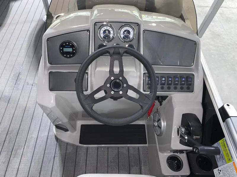 Slide: The Image of 2024 Starcraft EX22 FD boat dashboard with steering wheel and control panel. - 9