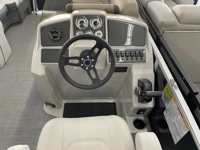 Slide: The Image of 2023 Starcraft EX 22 Q boat dashboard with steering wheel and control panel. - 10