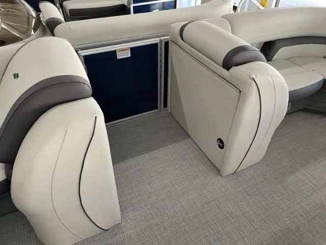 Slide: The Image of 2023 Starcraft EX 22 Q boat interior with white and gray seating. - 11