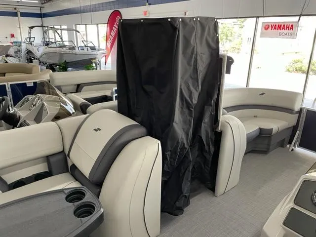 Slide: The Image of 2023 Starcraft EX 22 Q pontoon boat interior with beige and gray seating. - 12