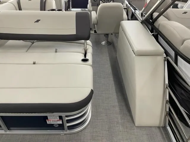 Slide: The Image of 2023 Starcraft EX 22 Q pontoon boat interior with plush seating and modern design. - 17