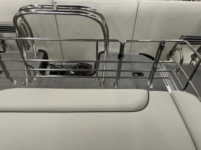 Slide: The Image of 2023 Starcraft EX 22 Q boat interior with stainless steel railings and cushioned seating. - 20