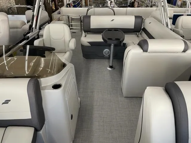 Slide: The Image of 2023 Starcraft EX 22 Q pontoon boat interior with luxurious seating and table. - 8