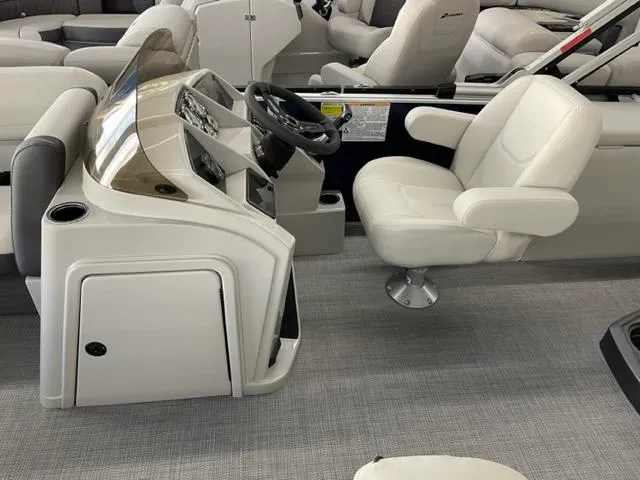 Slide: The Image of 2023 Starcraft EX 22 Q boat interior with captain's chair and control console. - 9