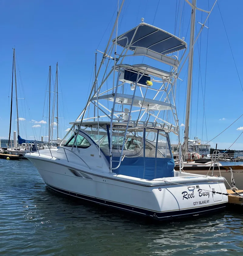 The Image of 2006 Tiara Yachts 3800 Open boat docked in a marina under clear blue skies. - 0