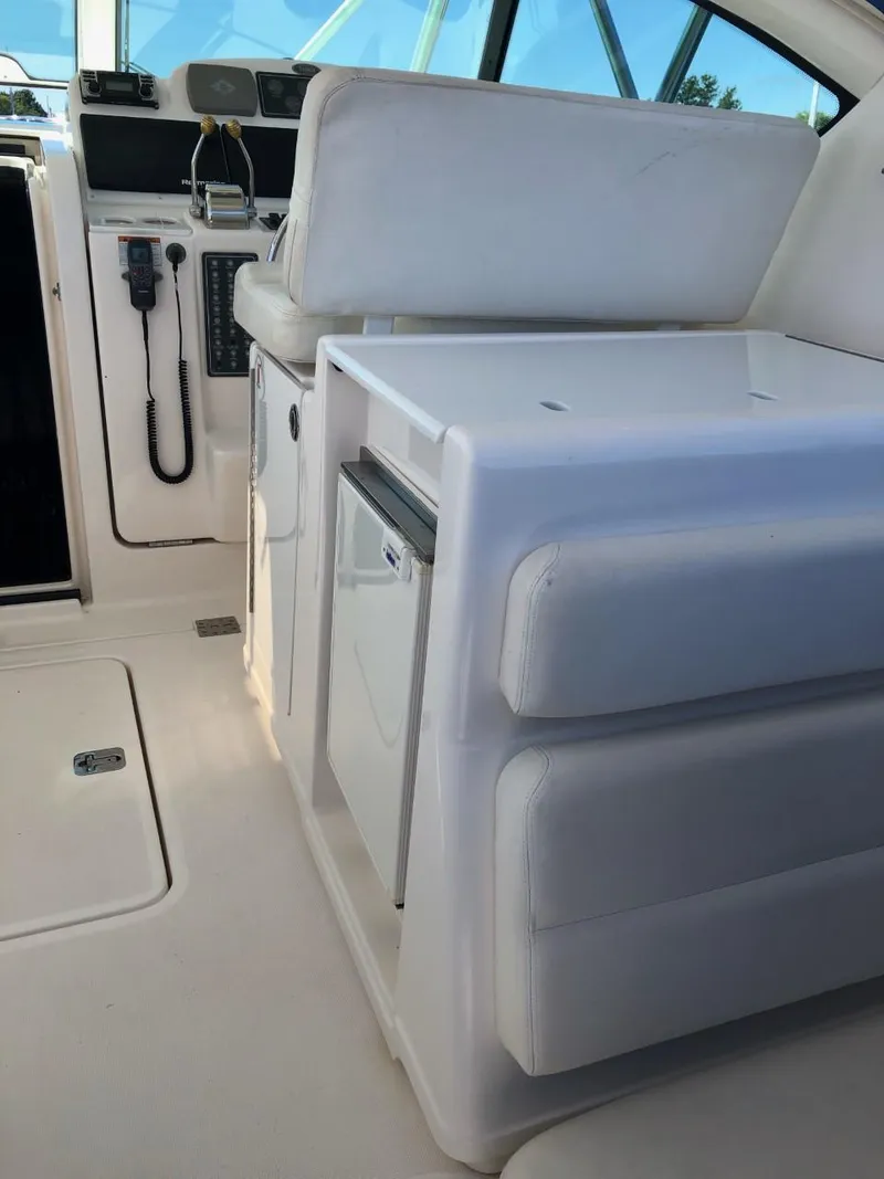 Slide: The Image of 2006 Tiara Yachts 3800 Open interior with white seating and control panel. - 13