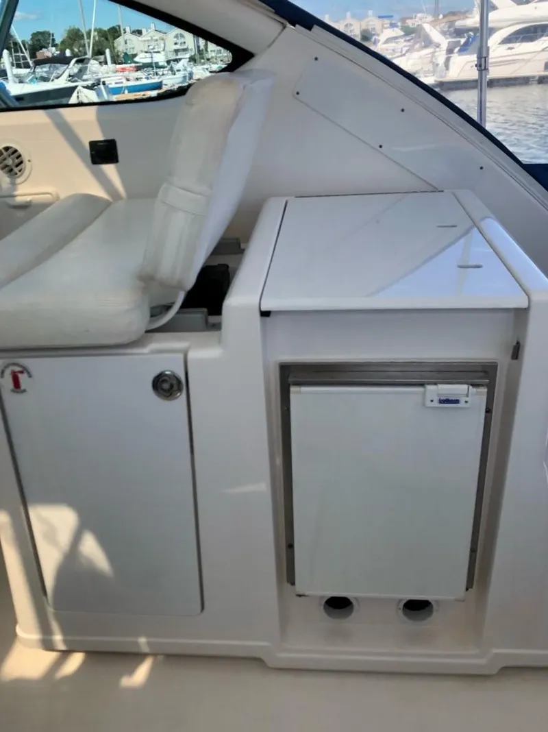 Slide: The Image of 2006 Tiara Yachts 3800 Open interior with seating and storage, docked at marina. - 14