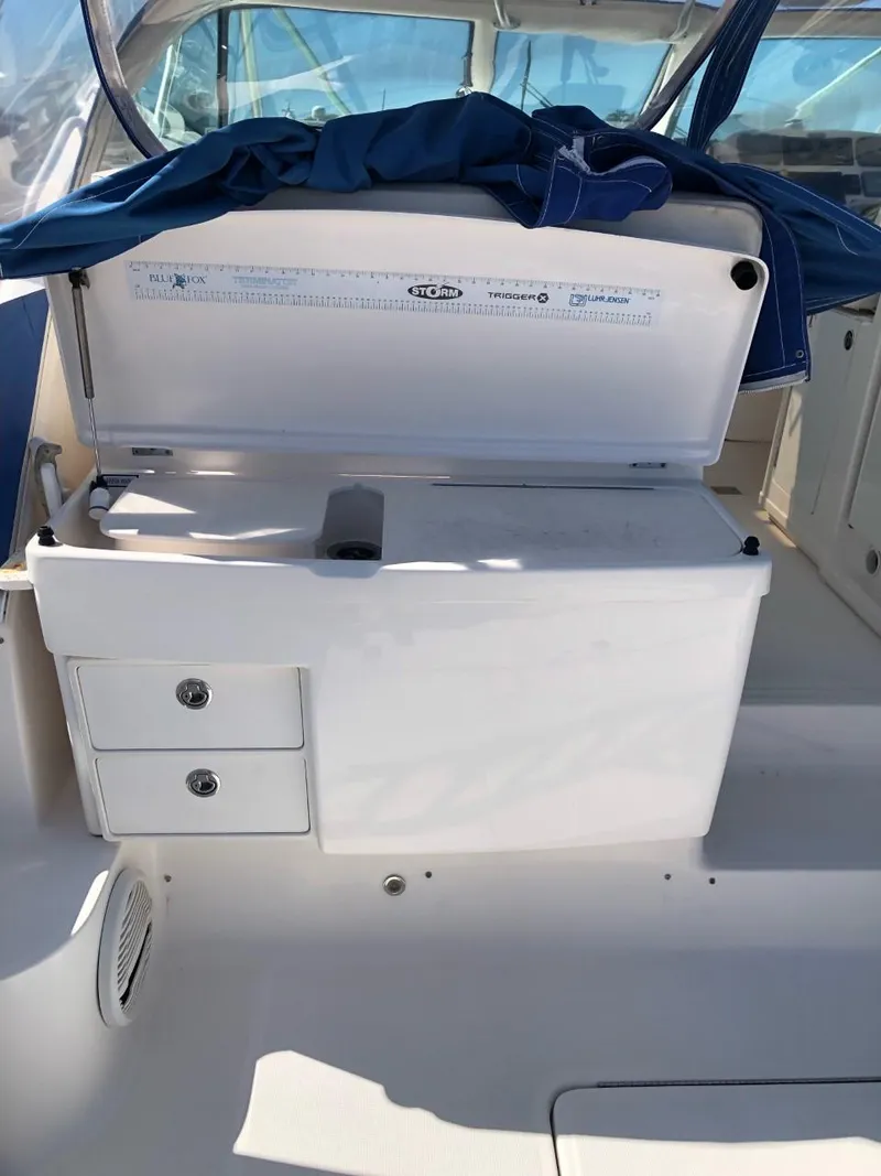 Slide: The Image of 2006 Tiara Yachts 3800 Open interior with storage compartments and measuring guide. - 15
