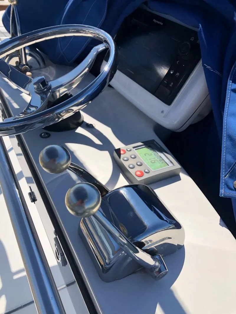 Slide: The Image of 2006 Tiara Yachts 3800 Open helm with steering wheel and control panel. - 16