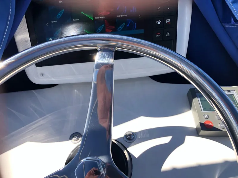 Slide: The Image of Steering wheel of a 2006 Tiara Yachts 3800 Open with control panel. - 17