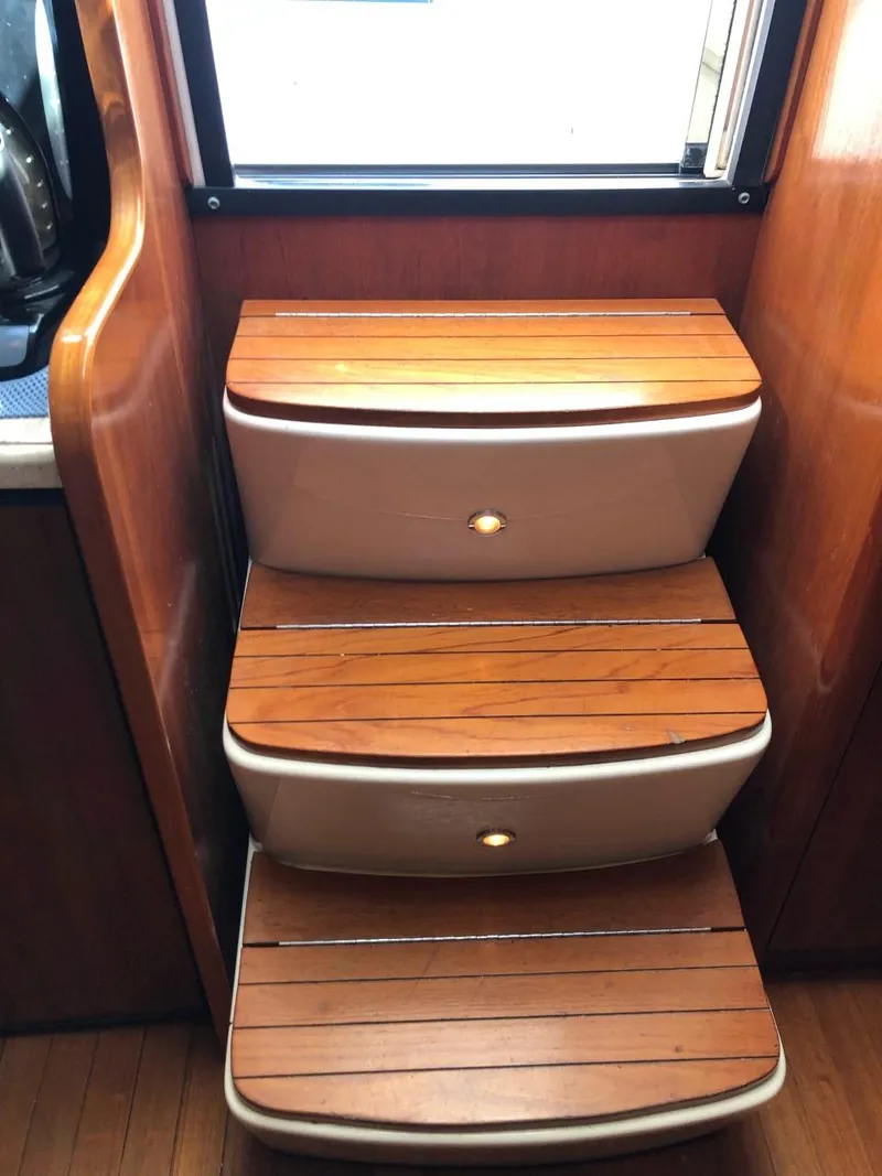 Slide: The Image of Wooden steps inside a 2006 Tiara Yachts 3800 Open, featuring elegant design and craftsmanship. - 20