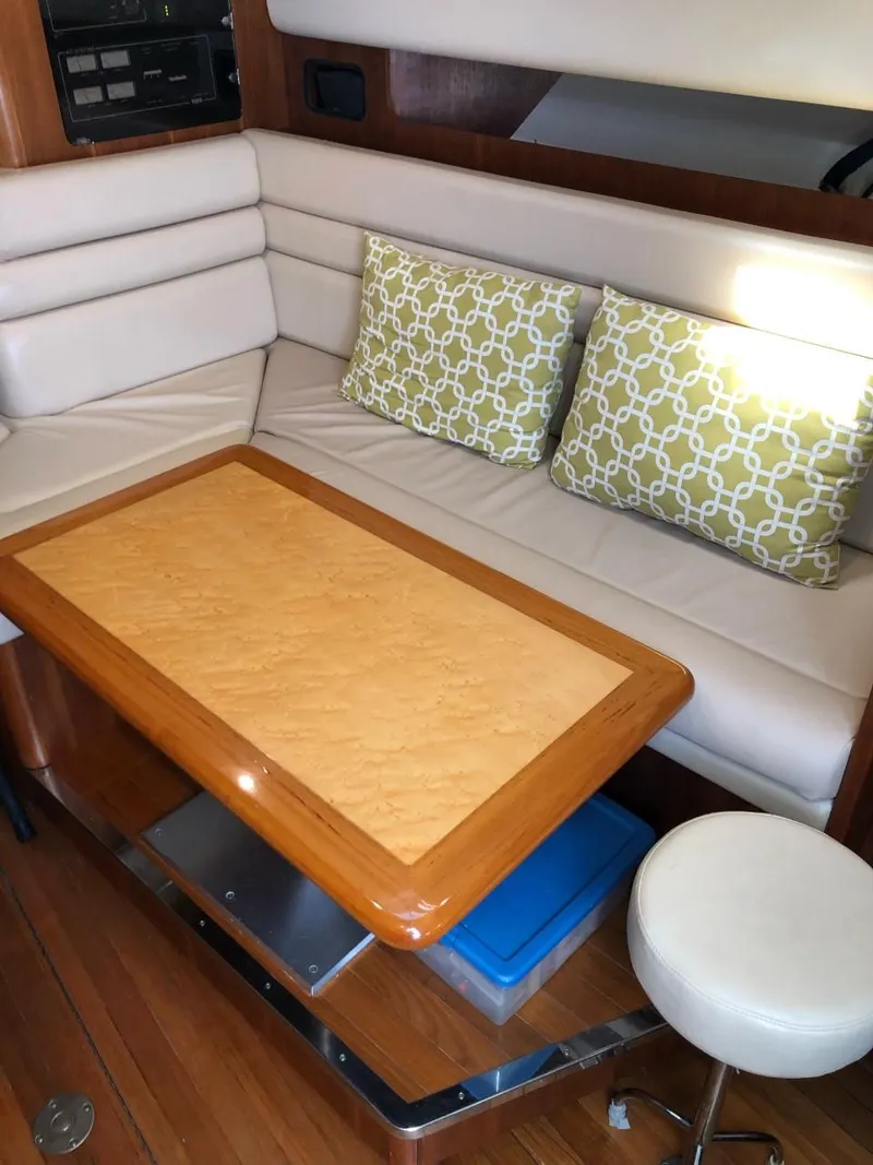 Slide: The Image of 2006 Tiara Yachts 3800 Open interior with cushioned seating and wooden table. - 21
