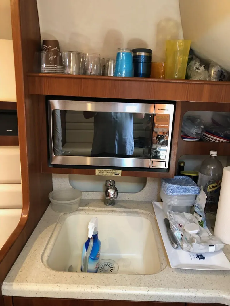 Slide: The Image of 2006 Tiara Yachts 3800 Open galley with microwave, sink, and storage. - 22