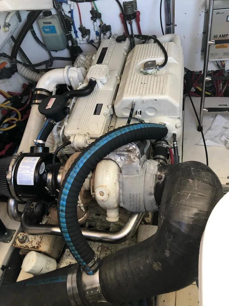 Slide: The Image of Engine compartment of a 2006 Tiara Yachts 3800 Open, showcasing mechanical components and wiring. - 26