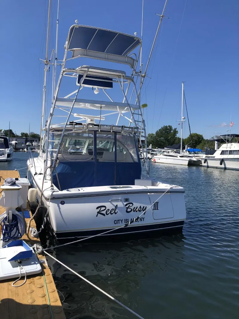 Slide: The Image of 2006 Tiara Yachts 3800 Open docked at marina, clear blue sky. - 5