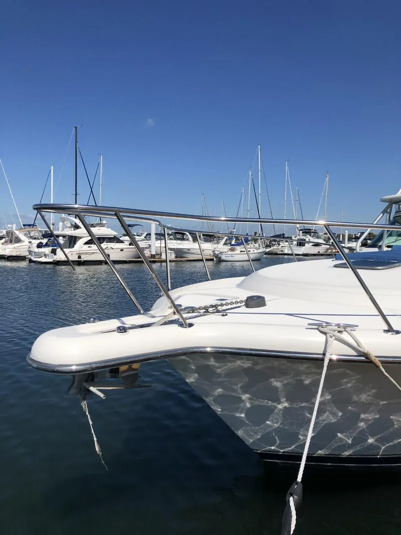 Slide: The Image of 2006 Tiara Yachts 3800 Open docked in a marina with other boats. - 6