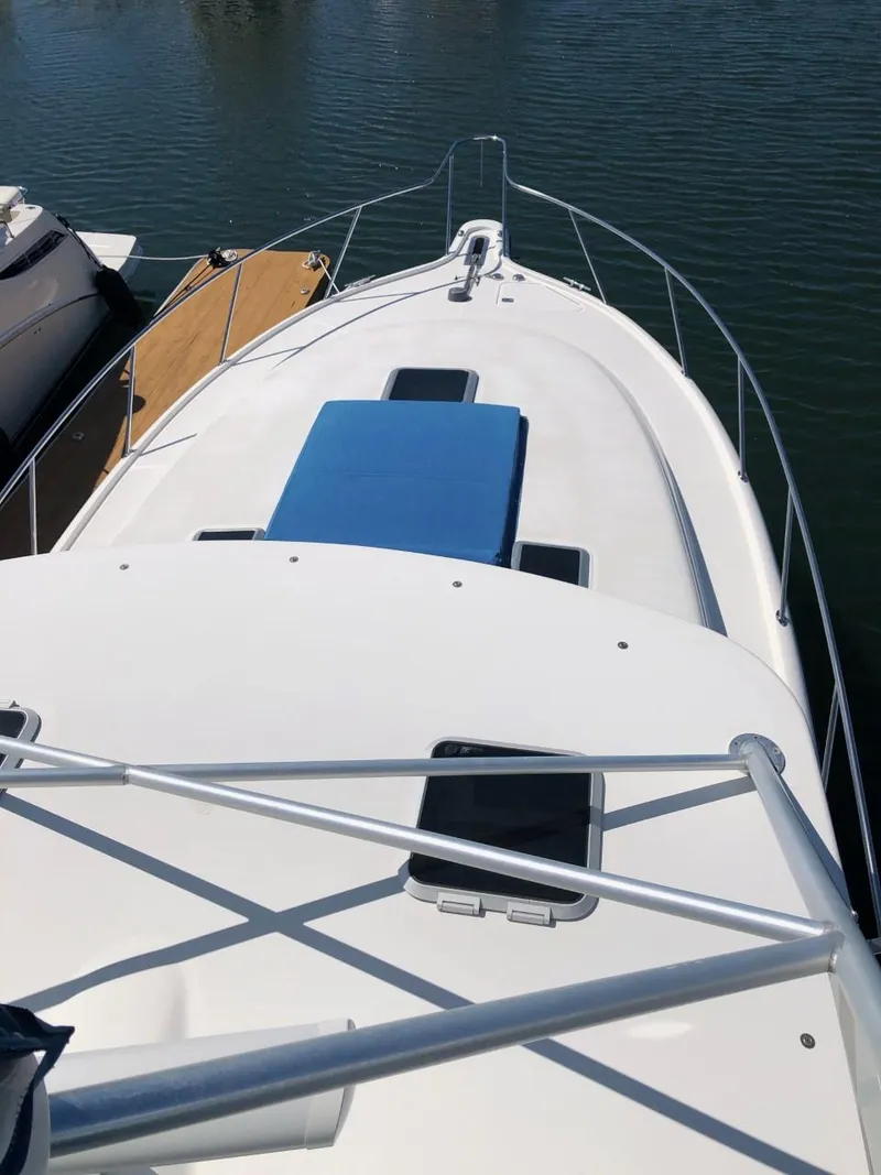 Slide: The Image of 2006 Tiara Yachts 3800 Open boat deck with railing and blue cushion. - 8