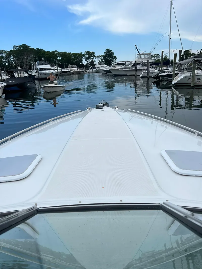 Slide: The Image of 2003 Formula 330 Sun Sport boat docked in a marina with other vessels. - 11